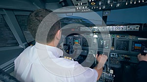 Two airmen in flight simulator, holding helms in a cockpit. 4K.