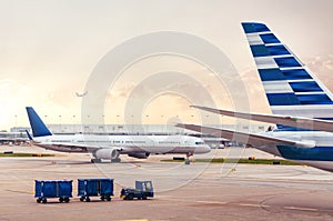 Two airplanes on tarmac with cargo at airport