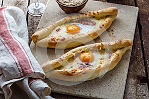 Two ajarian khachapuri, georgian bread with cheese and yolk