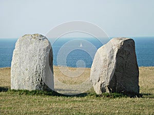 Two Ales Stenar boulders and a white sailboat, Sweden photo