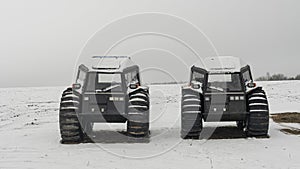 Two all-terrain vehicles on a winter background. Powerful off-road transporter. Engine, cross. Adventure concept