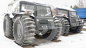 Two all-terrain vehicles on a winter background. Powerful off-road transporter. Engine, cross. Adventure concept