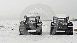 Two all-terrain vehicles on a winter background. Powerful off-road transporter. Engine, cross. Adventure concept