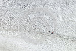 Two alpinists are hiking on snow photo