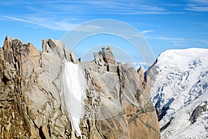 Two alpinists on top of cliff in the Alps