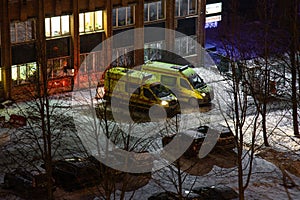 Two ambulance cars are waiting for a call. Ambulance in the night winter city. Calling a doctor at night. Health and medicine.