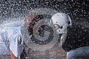 two american football players face to face in silhouette shadow on white background