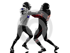 Two american football players on scrimmage holding