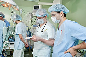 Two anaesthesiologist doctors at cardiac operation photo