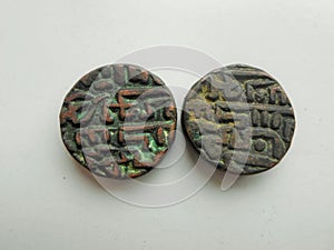 Two ancient coins on white background