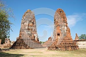 Two ancient prangs of the Buddhist temple of Wat Mahathat on a sunny day. Ayutthaya, Thailand