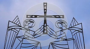 Two angels holding a cross
