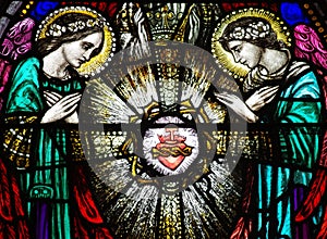 Two angels with the sacred heart in stained glass photo