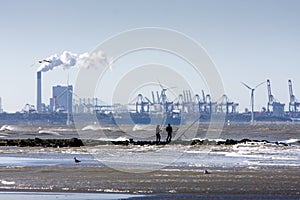 Two anglers on a pier of the dutch coast