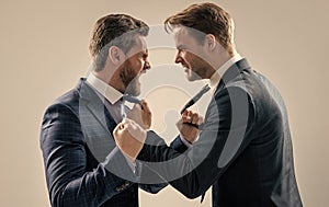 two angry businessmen punching in fight and arguing having struggle, aggressive negotiations.