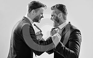 two angry businessmen punching in fight and arguing having struggle, aggressive negotiations.