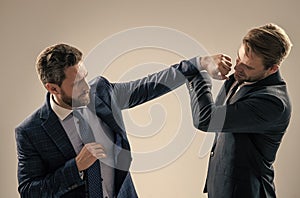 two angry businessmen punching in fight because of business competition, business knockout.