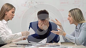 Two angry businesswoman having dispute at business team meeting showing financial paper documents