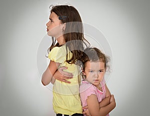 Two angry sisters standing back to back