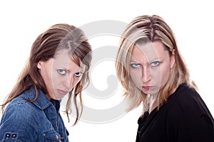 Two angry woman faces the viewer