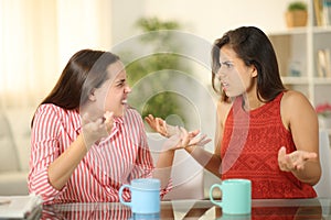 Two angry women at home arguing