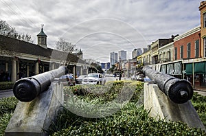 Two antique cannons pointing out towards Decatur Street in the French Quarter