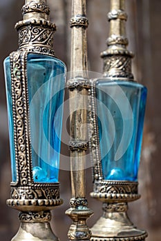 Two antique perfume bottles with blue cut crystal with a silver metal base