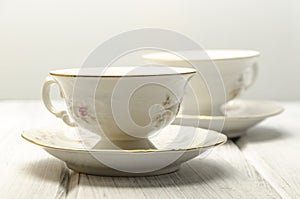 two antique teacups on white background