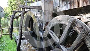 Two antique water wheels of a water mill in the Black Forest with a mill wheel spinning