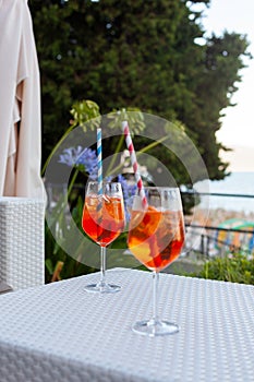 Two aperol spritz on a summer evening in a mediterranean pub