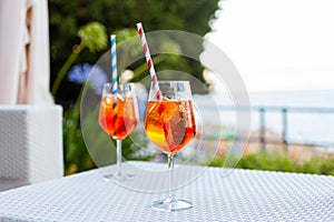 Two aperol spritz on a summer evening in a mediterranean pub