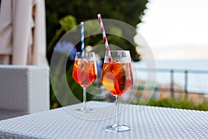 Two aperol spritz on a summer evening in a mediterranean pub