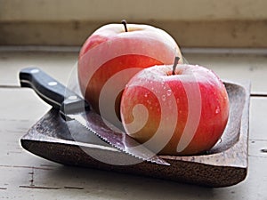 Two Apples on the Wooden Plate
