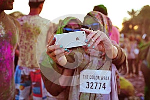 Two Arab women wearing Hijabs take an iPhone selfie at the Color Walk in Dubai, United Arab Emirates.