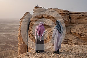 Two Arab men in traditional clothing at the Edge of the World near Riyadh in Saudi Arabia
