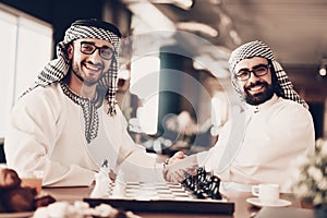 Two arab shaking hands before playing chess