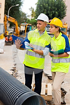 Two architects with laptop discussing construction plan