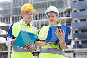 Two architects with laptop discussing construction plan