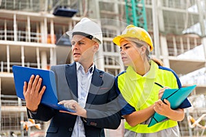 Two architects with laptop discussing construction plan