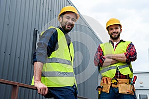 two architects in safety vests and hardhats standing