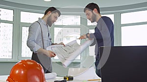 Two architects shake hands at the office