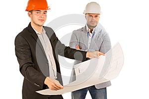 Two architects studying a building blueprint