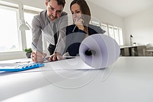 Two architects at work in their office