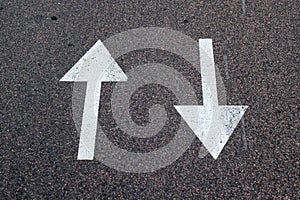 Two arrows on asphalt. Sign of two-way street.