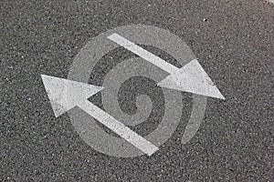 Two arrows on asphalt. Sign of two-way street