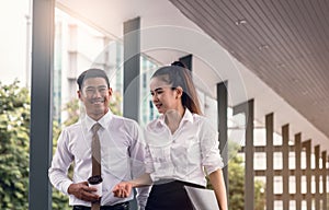 Two asian businees people couple consulting about work in morning time.