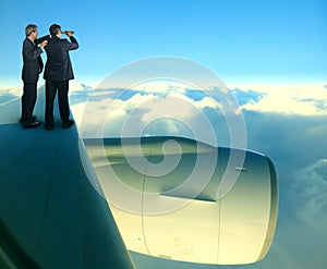 Two of asian business man standing on jet plane wing over white