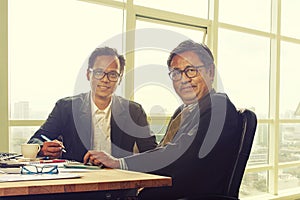 Two asian business man toothy smiling face in working office