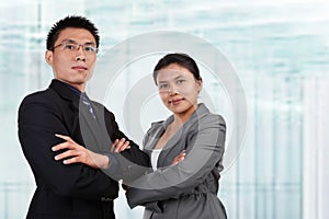 Two Asian business people pose