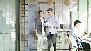 Two asian business people working together in office